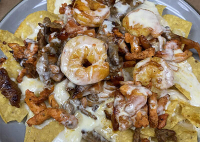 Texas nachos with chicken, shrimp and steak